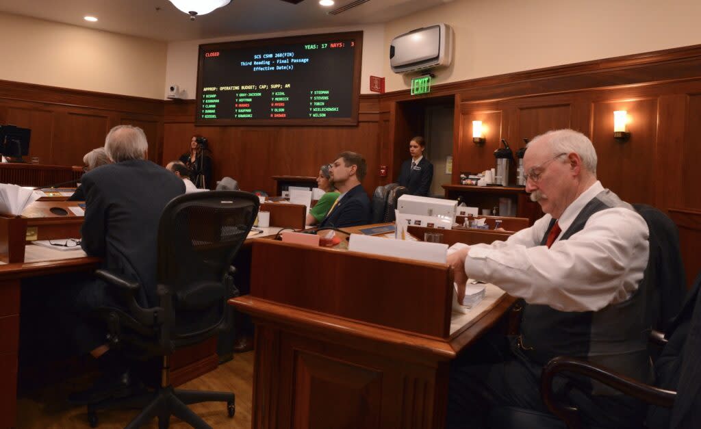 Sen. Bert Stedman, R-Sitka, puts away his notes after debate on the state operating budget, Wednesday, May 1, 2024, as the Senate's tally board displays the vote on the budget's effective date. (Photo by James Brooks/Alaska Beacon)