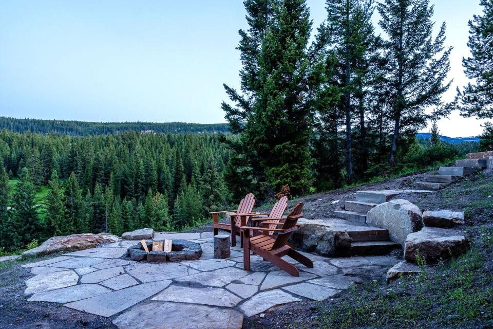 Outdoor seating and fire pit at home rental in Big Sky, Montana