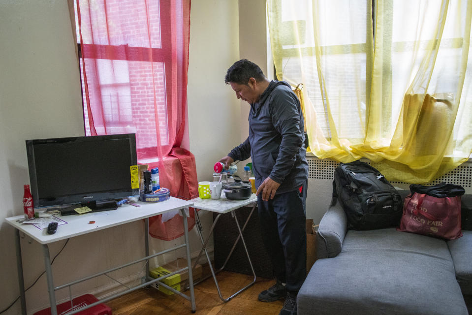 Ecuadorian immigrant Neptali Chiluisa is photographed inside the room he rents in a Bronx apartment he shares with other Ecuadorian families, on Thursday, Oct. 21, 2021, in New York. Chiluisa crossed the border in June in Arizona and was detained for a week with his 14-year-old son, leaving behind his wife and three other children in Ecuador. The son returned in August because Chiluisa had to work and couldn’t find a nearby school with space. He acknowledges coming for economic reasons and wonders if he has any options for temporary legal status. (AP Photo/Eduardo Munoz Alvarez)