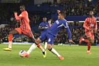 Chelsea's Thiago Silva, centre, challenges for the ball with Everton's Abdoulaye Doucoure during the English Premier League soccer match between Chelsea and Everton at Stamford Bridge stadium in London, Monday, April 15, 2024. (AP Photo/Ian Walton)