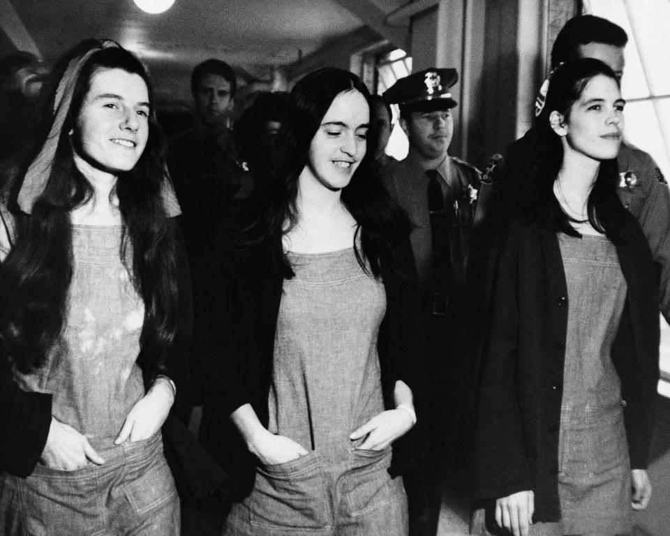 FILE - In this Jan. 25, 1971, file photo, three members of Charles Manson's hippie style clan leave a Los Angeles courtroom just after being found guilty, along with Manson of first degree murder, in Los Angeles. From left are Patricia Krenwinkel, Susan Atkins and Leslie Van Houten. (AP Photo/Pool, File)