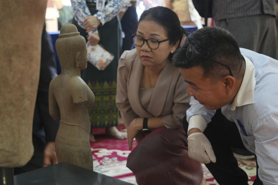 Museum staff members prepare an artifact returned from U.S to Cambodia, before an official ceremony at the Cambodian National Museum in Phnom Penh Cambodia, Thursday, July 4, 2024. Cambodia on Thursday officially organized a welcome ceremony for the arrival of more than a dozen rare Angkor era sculptures from New York's Metropolitan Museum of Art that were tied to an art dealer and collector accused of running a huge antiquities trafficking network out of Southeast Asia. (AP Photo/Heng Sinith)