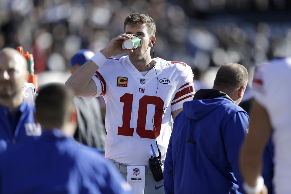 Eli Manning is still a member of the New York Giants organization. The man who benched him last week, Ben McAdoo, is not. (AP)