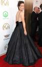 in a plunging black gown with feather and sheen accents at the 30th Annual Producers Guild Awards.