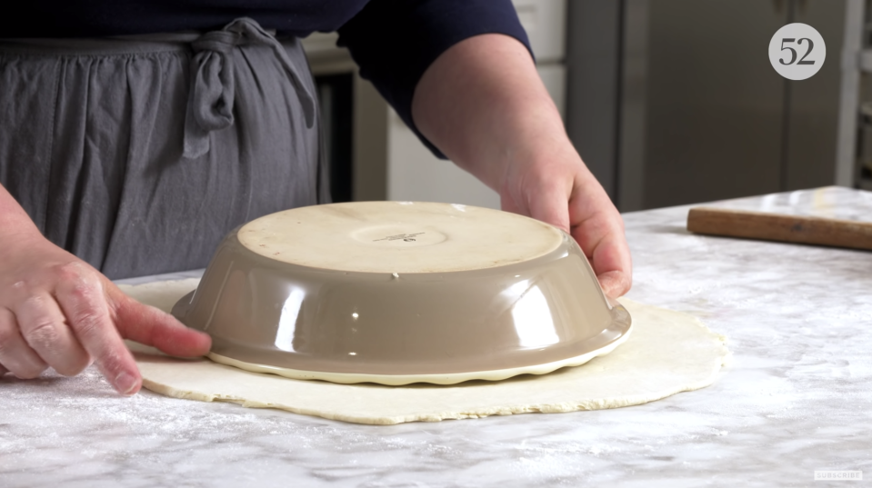 Leave two inches all the way around, maybe even a bit more if you're using a deep dish pie plate.