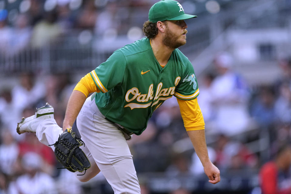 Oakland Athletics starting pitcher Cole Irvin watches a throw during the first inning of the team's baseball game against the Atlanta Braves on Tuesday, June 7, 2022, in Atlanta. (AP Photo/John Bazemore) Oakland Athletics