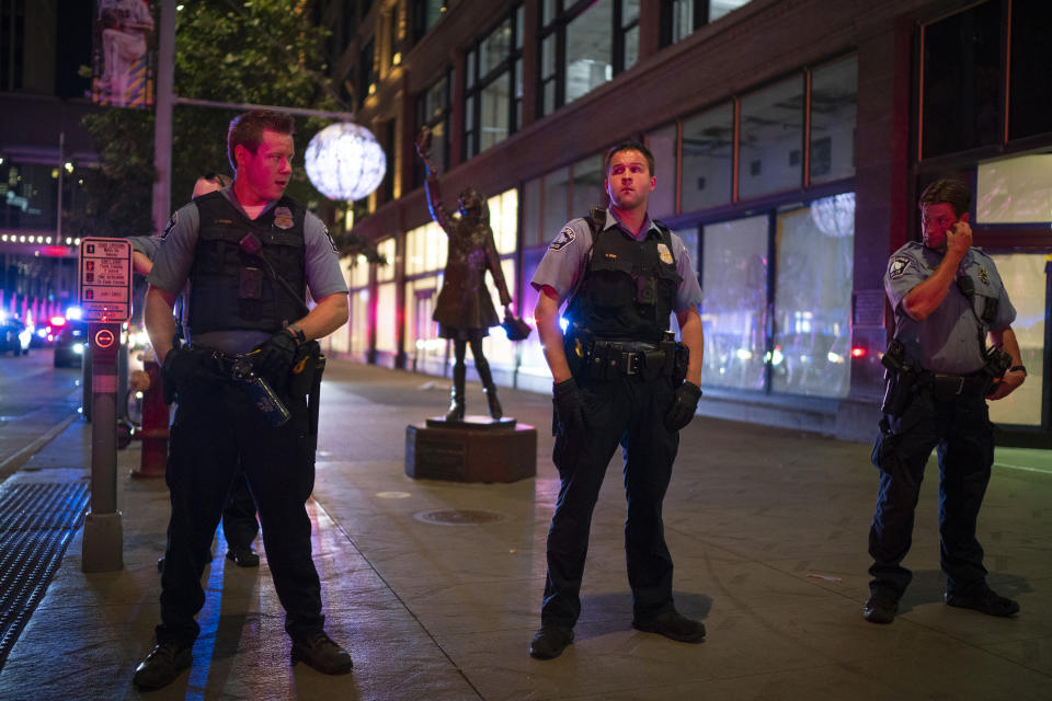 Minneapolis Police form a line on the Nicollet Mall at S. 7th St. near where a Foot Locker store was looted Wednesday, Aug. 26, 2020 in Minneapolis. The Minneapolis mayor imposed a curfew Wednesday night and requested National Guard help after unrest broke out downtown following what authorities said was misinformation about the death of a Black homicide suspect. (Jeff Wheeler/Star Tribune via AP)