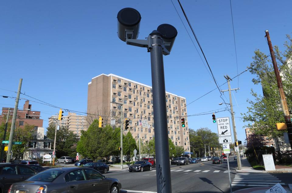 Camera flashes are trained on Pennsylvania Avenue in the direction toward downtown at Franklin Street as part of the red light camera system monitoring traffic at the intersection.