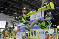 The Zip Flyer zip line display shows various harnesses that riders can wear at the International Association of Amusement Parks and Attractions convention Tuesday, Nov. 19, 2019, in Orlando, Fla. (AP Photo/John Raoux)