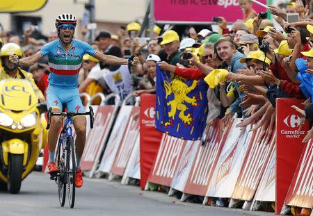 Astana rider Vincenzo Nibali of Italy celebrates as he crosses the finish line to win the 138-km (85.74 miles) 19th stage of the 102nd Tour de France cycling race from Saint-Jean-de-Maurienne to La Toussuire-Les Sybelles in the French Alps mountains, France, July 24, 2015. REUTERS/Stefano Rellandini