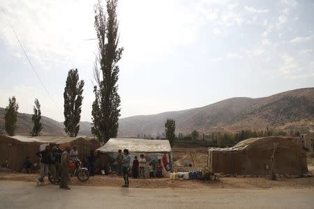 Syrian refugees from Raqqa rest near their tents in the Bekaa valley, Lebanon October 19, 2015. REUTERS/Alia Haju