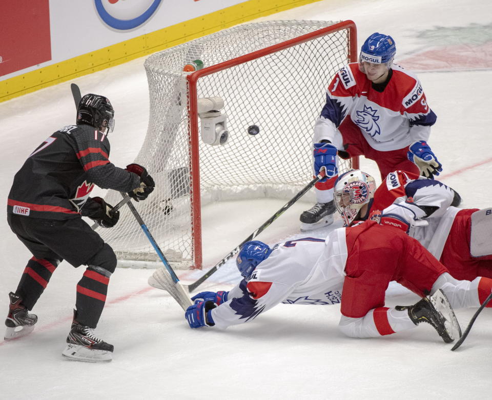 Canada's Connor McMichael scores Canada's fourth goal of the game as Czech Republic's Martin Has (7) goaltender Lukas Parik and Tomas Dajcar (9) look on during the first period at the World Junior Hockey Championships on Tuesday, Dec. 31, 2019 in Ostrava, Czech Republic. (Ryan Remiorz/The Canadian Press via AP)