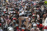 People attend the funeral of Angel a 19-year-old protester also known as Kyal Sin who was shot in the head as Myanmar forces opened fire to disperse an anti-coup demonstration in Mandalay