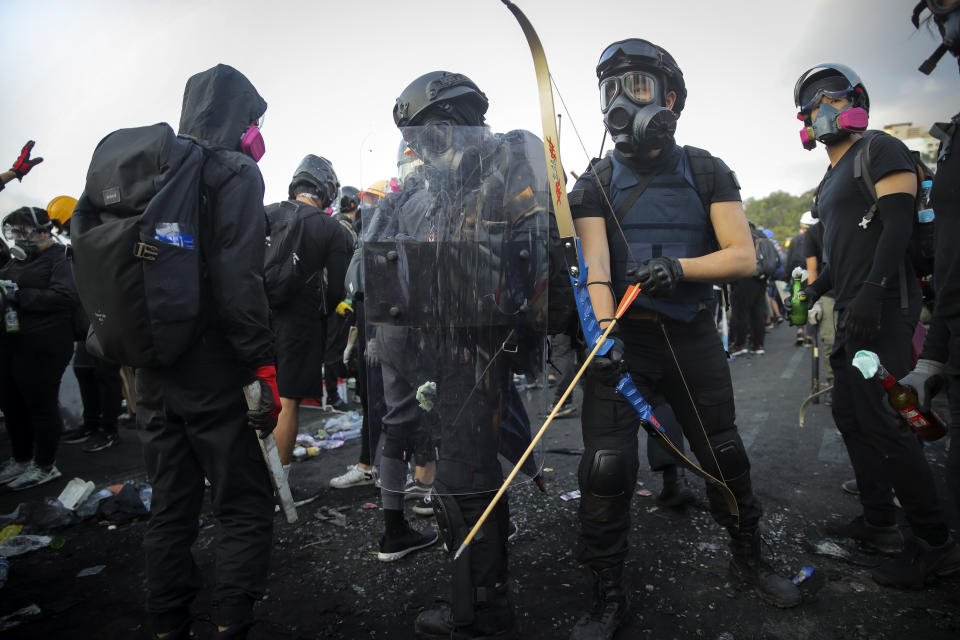 Students with their homemade gears take their position outside the Chinese University of Hong Kong, in Hong Kong, Wednesday, Nov. 13, 2019. Protesters in Hong Kong battled police on multiple fronts on Tuesday, from major disruptions during the morning rush hour to a late-night standoff at a prominent university, as the 5-month-old anti-government movement takes an increasingly violent turn. (AP Photo/Kin Cheung)