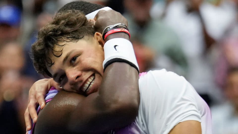 Tiafoe hugs Shelton at the net after Tiafoe's come-from-behind win Friday. - Seth Wenig/AP