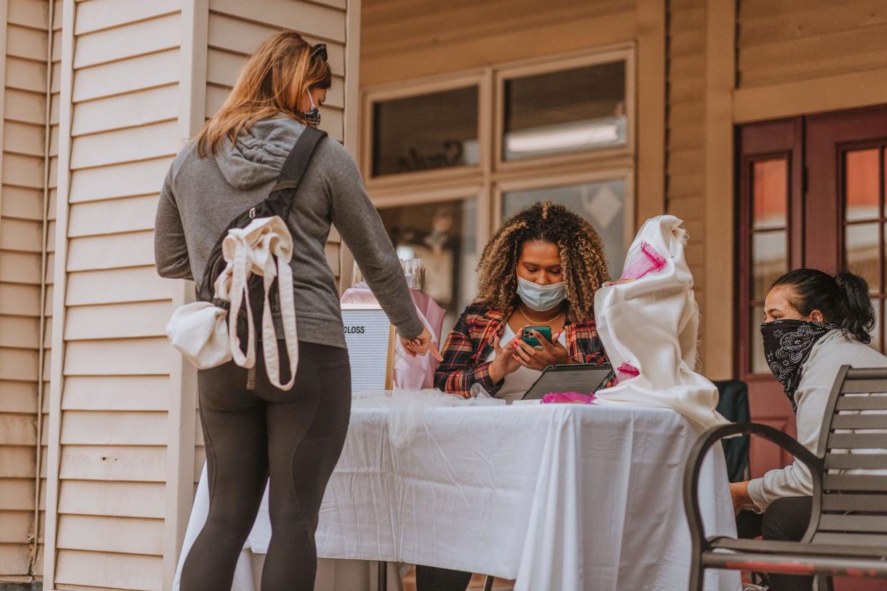 A customer completes a transaction with a vendor at Holland Town Center's Artisan Markt. The same organizer and many vendors will hold a holiday market at The Shops at Westshore on Saturday, Dec. 4.