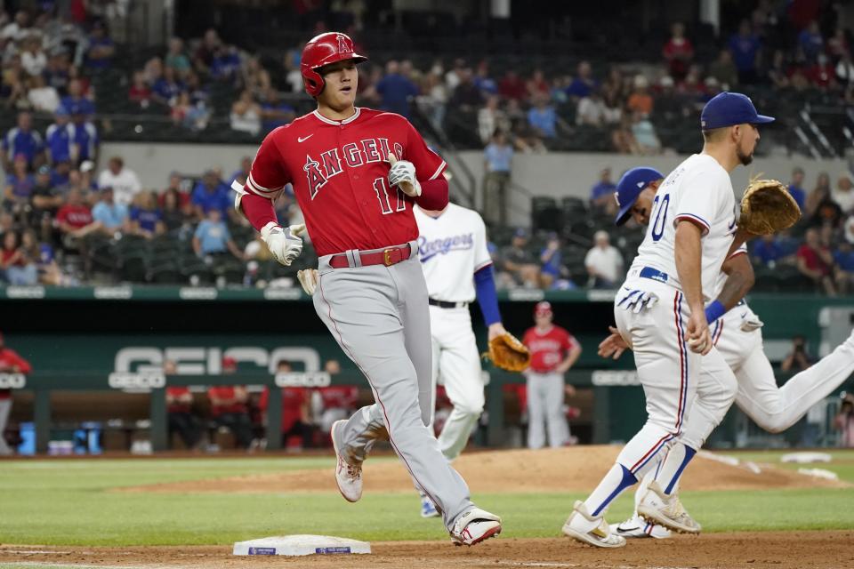 Los Angeles Angels' Shohei Ohtani (17) runs out a ground out to second as Texas Rangers first baseman Nathaniel Lowe, right, stands by the bag in the seventh inning of a baseball game in Arlington, Texas, Wednesday, Sept. 29, 2021. (AP Photo/Tony Gutierrez)