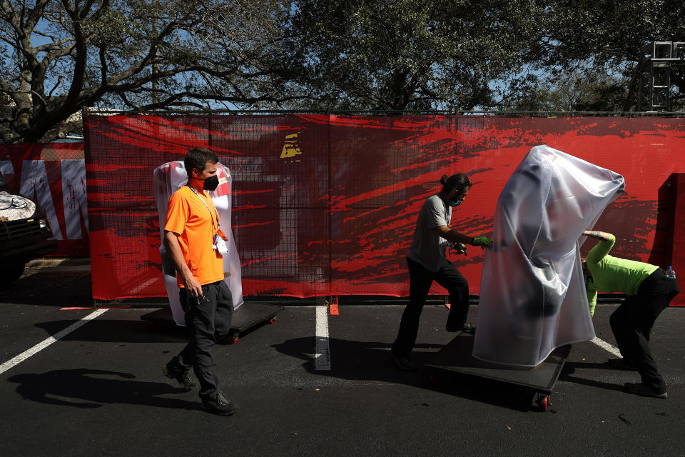 Workers cover NFL team models before Super Bowl LV between the Tampa Bay Buccaneers and the Kansas City Chiefs at Raymond James Stadium on February 07, 2021 in Tampa, Florida. (Photo by Patrick Smith/Getty Images)