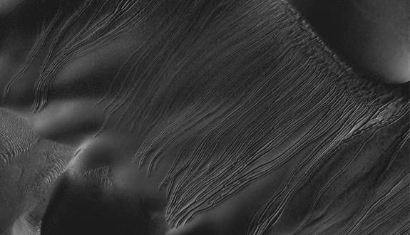 Several types of downhill flow features have been observed on Mars. This image from NASA's Mars Reconnaissance Orbiter is an example of a type called "linear gullies."