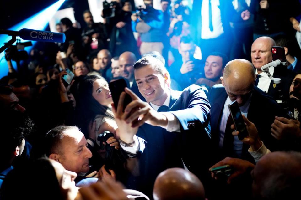 Bardella takes a selfie with supporters at a meeting, in Marseille on March 3, 2024.<span class="copyright">Daniel Cole—AP</span>