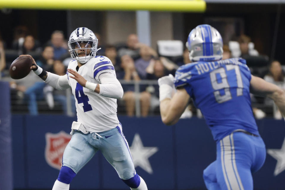 Dallas Cowboys quarterback Dak Prescott (4) is pressured by Detroit Lions defensive end Aidan Hutchinson (97) during the second half of an NFL football game, Sunday, Oct. 23, 2022, in Arlington, Texas. (AP Photo/Ron Jenkins)