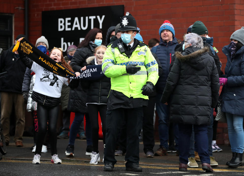 CROSBY, ENGLAND - JANUARY 10: A policeman stands in-front of Newport fans prior to the FA Cup Third Round match between Marine and Tottenham Hotspur at Rossett Park on January 10, 2021 in Crosby, England. Sporting stadiums around England remain under strict restrictions due to the Coronavirus Pandemic as Government social distancing laws prohibit fans inside venues resulting in games being played behind closed doors. (Photo by Tottenham Hotspur FC/Tottenham Hotspur FC via Getty Images)