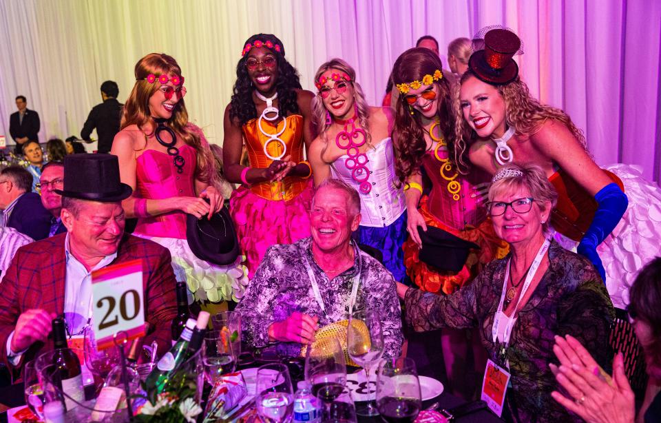 Scott and Mary Fischer, right, celebrate a winning bid during the SWFL Wine & Food Fest at Suncoast Credit Union Arena in Fort Myers on Saturday, Jan. 20, 2024. The auction raised over $2 million.