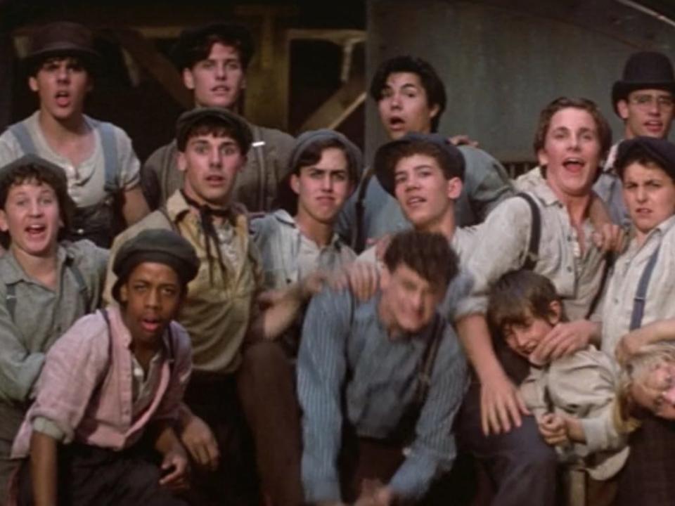 newsboys posing for the newspaper photo in Newsies