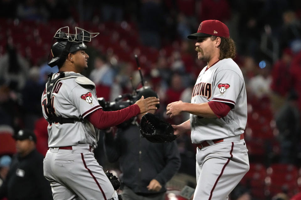 Arizona Diamondbacks relief pitcher Andrew Chafin, right, and catcher Gabriel Moreno celebrate a 6-3 victory over the St. Louis Cardinals in a baseball game Monday, April 17, 2023, in St. Louis. (AP Photo/Jeff Roberson)