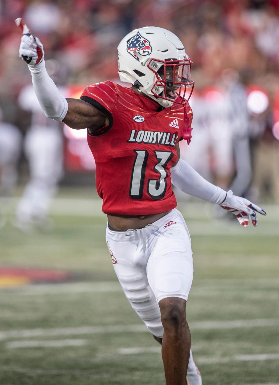 Louisville's Kei'Trel Clark, 13, celebrates after intercepting and Eastern Kentucky' pass doing first half action. Sept. 11, 2021