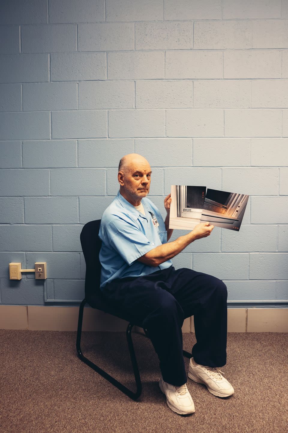 a man sitting in a chair reading a book