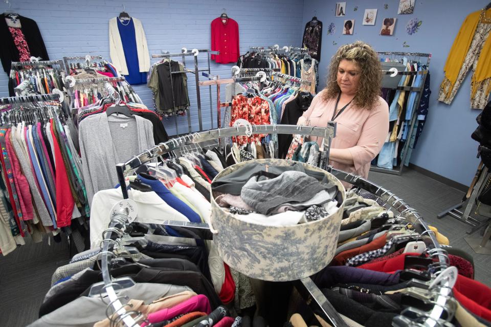 Allison Reed, YWCA Career and Fashion boutique manager puts out some clothing at the shop in the Alliance Commons.