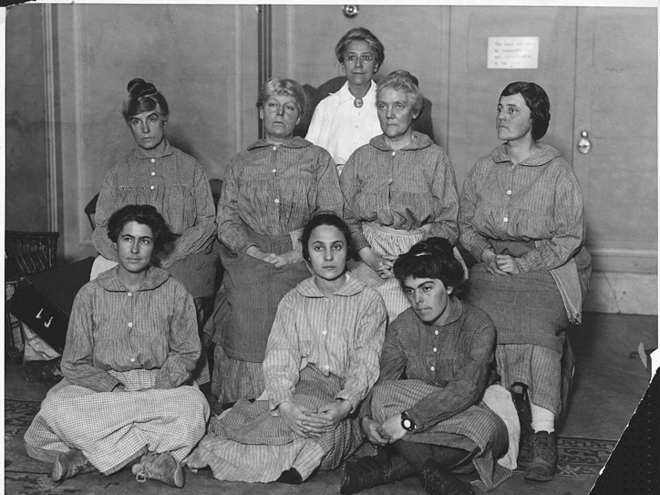 Suffragists attend a meeting of the National Women's Party in New York wearing their prison garb to describe their experiences.