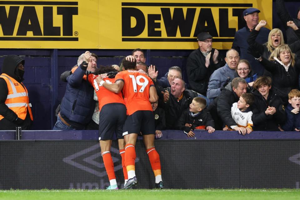 Tahith Chong celebrates with Jacob Brown (19) and the Kenilworth Road fans after his goal put Luton ahead (Getty)