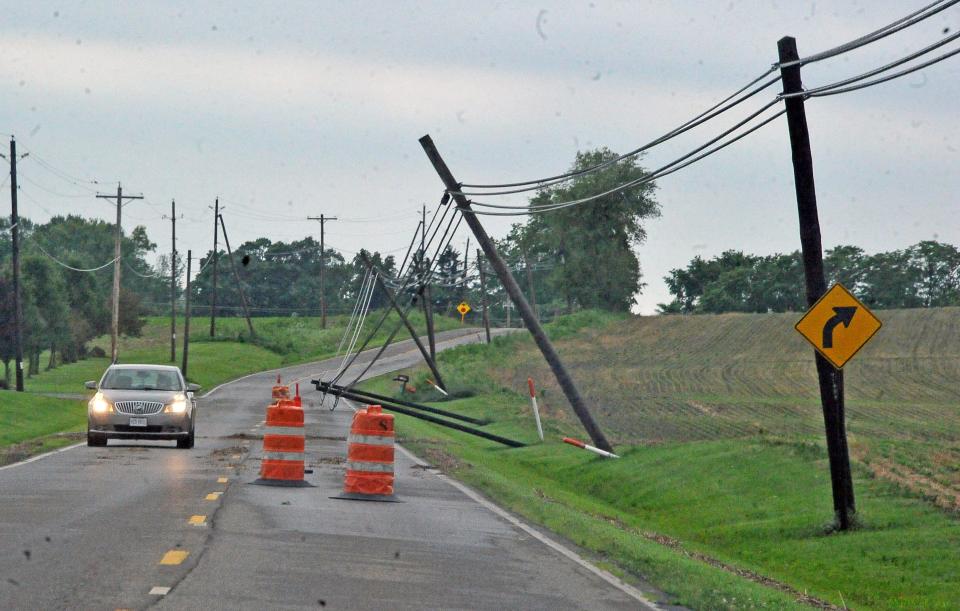 Utility poles were blown over south of Wooster by strong winds from the overnight storm.