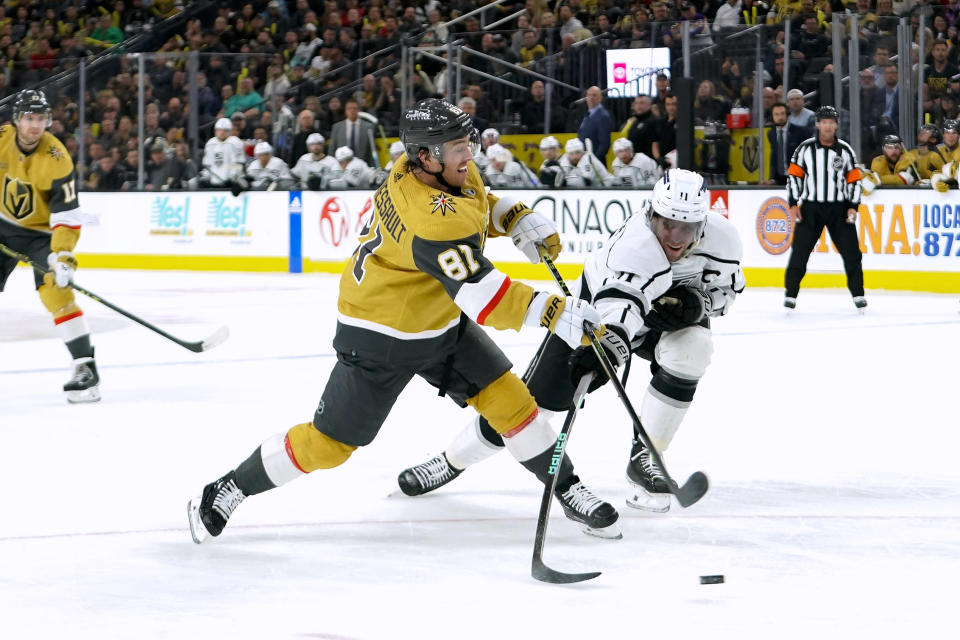 Vegas Golden Knights center Jonathan Marchessault (81) shoots the puck as Los Angeles Kings center Anze Kopitar (11) defends during the second period of an NHL hockey game Thursday, April 6, 2023, in Las Vegas. (AP Photo/Lucas Peltier)