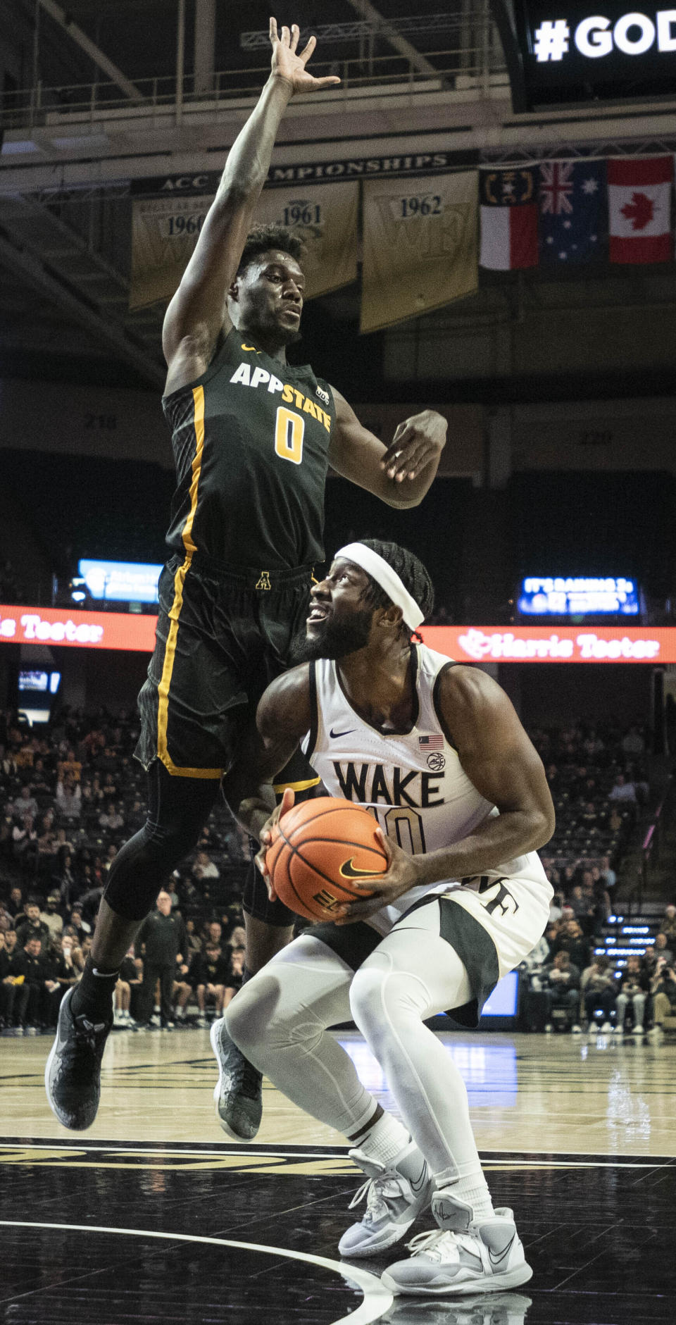 Appalachian State guard Xavion Brown (0) applies pressure to Wake Forest guard Jao Ituka (10) in the first half of an NCAA college basketball game on Wednesday, Dec. 14, 2022, at Joel Coliseum in Winston-Salem, N.C. (Allison Lee Isley/The Winston-Salem Journal via AP)