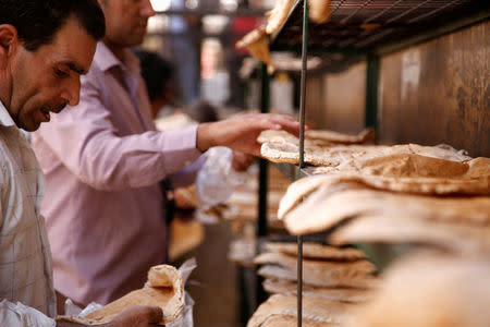 Men arrange bread to be cooled in Damascus, Syria September 17, 2016. REUTERS/Omar Sanadiki/File photo