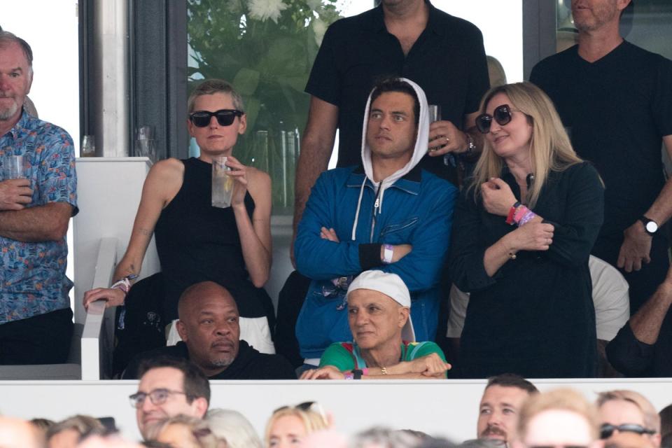 Corrin (left) and Malek watch Bruce Springsteen and the E Street Band performing on stage at BST Hyde Park (PA)