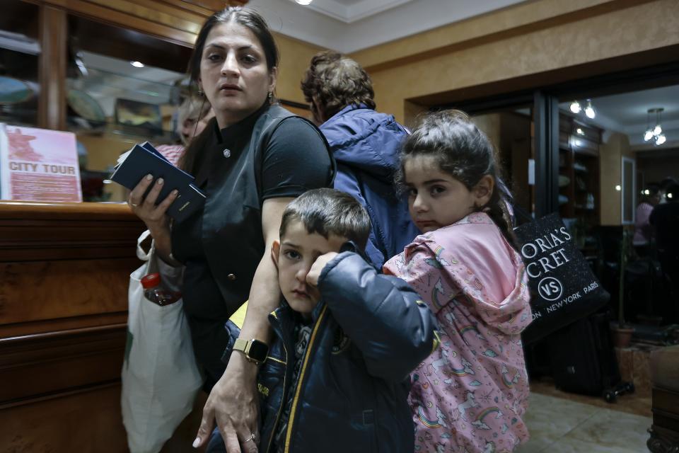 Ethnic Armenians from the first group of about 30 people from Nagorno-Karabakh to Armenia lineup waiting to be temporarily checked into a hotel in Goris, the town in Syunik region, Armenia, Sunday, Sept. 24, 2023. The first refugees from Nagorno-Karabakh have arrived in Armenia, local officials reported Sunday, and more were expected to come after a 10-month blockade and a lightning military offensive this month that resulted in Azerbaijan reclaiming full control of the breakaway region. (AP Photo/Vasily Krestyaninov)