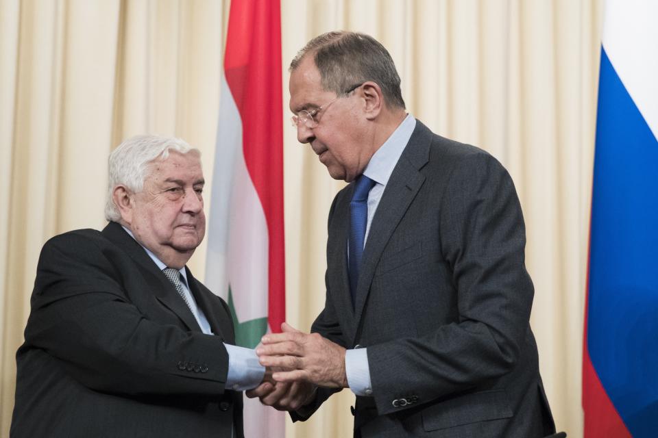 Russian Foreign Minister Sergey Lavrov, right, shakes hand with Syrian Foreign Minister Walid Muallem, after a shared press conference with Iranian Foreign Minister Mohammad Javad Zarif following their talks focused on Syria in Moscow, Russia, Friday, April 14, 2017. (AP Photo/Pavel Golovkin)