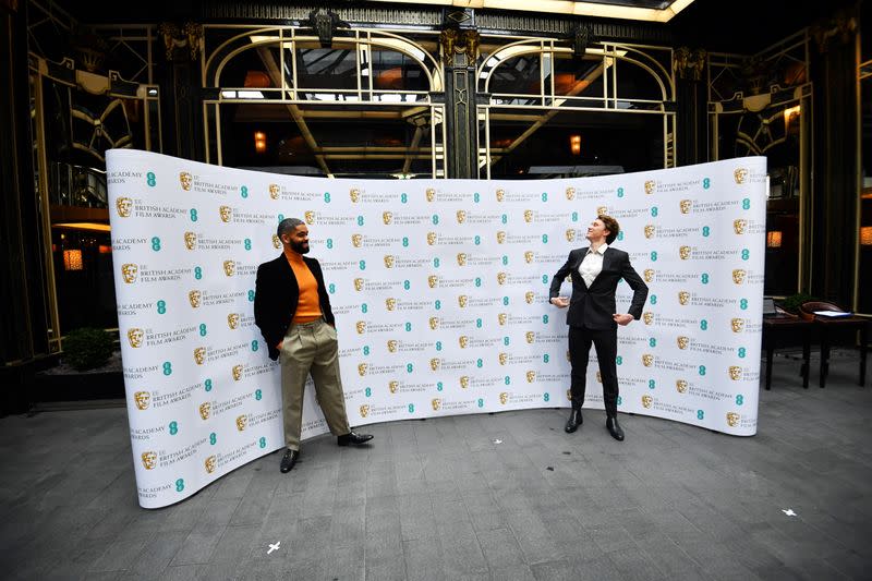 British actor Kingsley Ben-Adir shares a light moment with previous nominee George MacKay as he celebrates being nominated for the 2021 Rising Star Award in London