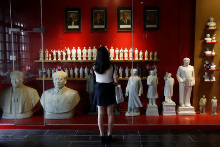 A visitor looks at a display of porcelain figures of the late Chinese Chairman Mao Zedong at Jianchuan Museum Cluster in Anren, Sichuan Province, China, May 13, 2016. REUTERS/Kim Kyung-Hoon