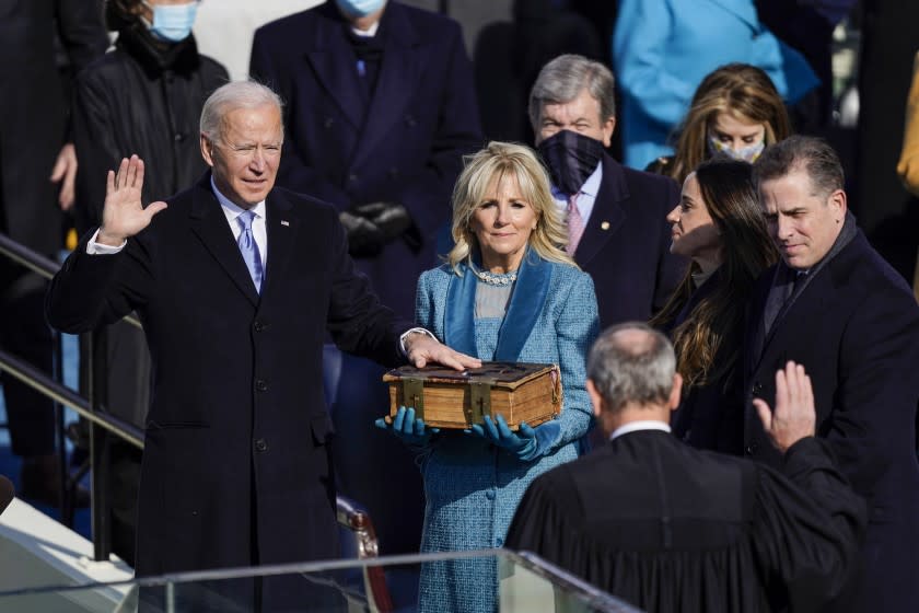 Washington , DC - January 20: U.S. President-elect Joe Biden takes the oath of office from Supreme Court Chief Justice John Roberts as his wife U.S. First Lady-elect Jill Biden stands next to him during the 59th presidential inauguration in Washington, D.C. on Wednesday, Jan. 20, 2021. . (Kent Nishimura / Los Angeles Times)