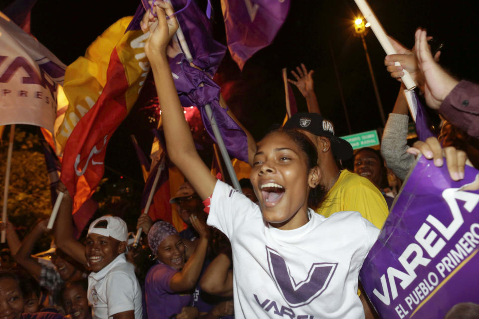 Supporters of Juan Carlos Varela, Panama's president elect, celebrate in the street after Varela delivered his acceptance speech in Panama City, Sunday, May 4, 2014. Varela was declared the victor of Panama's presidential election, thwarting an attempt by former ally President Ricardo Martinelli to extend his grip on power by electing a hand-picked successor. (AP Photo/Tito Herrera)