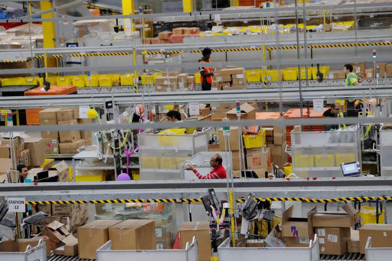 FILE PHOTO: FILE PHOTO: Amazon workers perform their jobs inside of an Amazon fulfillment center on Cyber Monday in Robbinsville, New Jersey