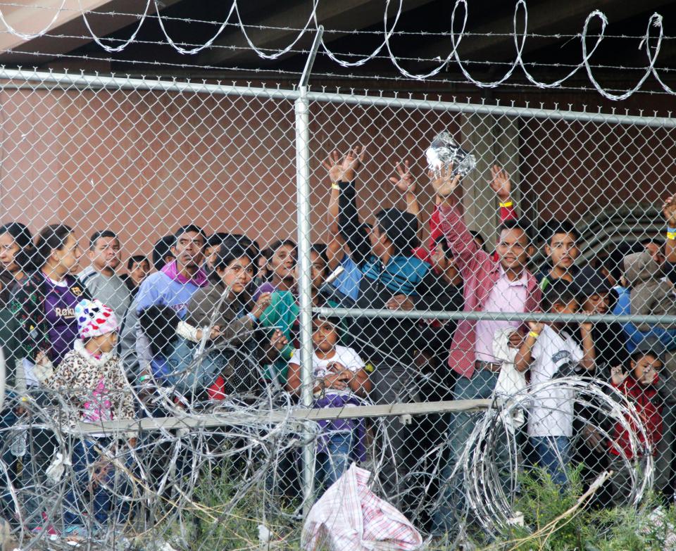 In this March 27, 2019, file photo, Central American migrants wait for food in a pen erected by U.S. Customs and Border Protection to process a surge of migrant families and unaccompanied minors in El Paso, Texas.