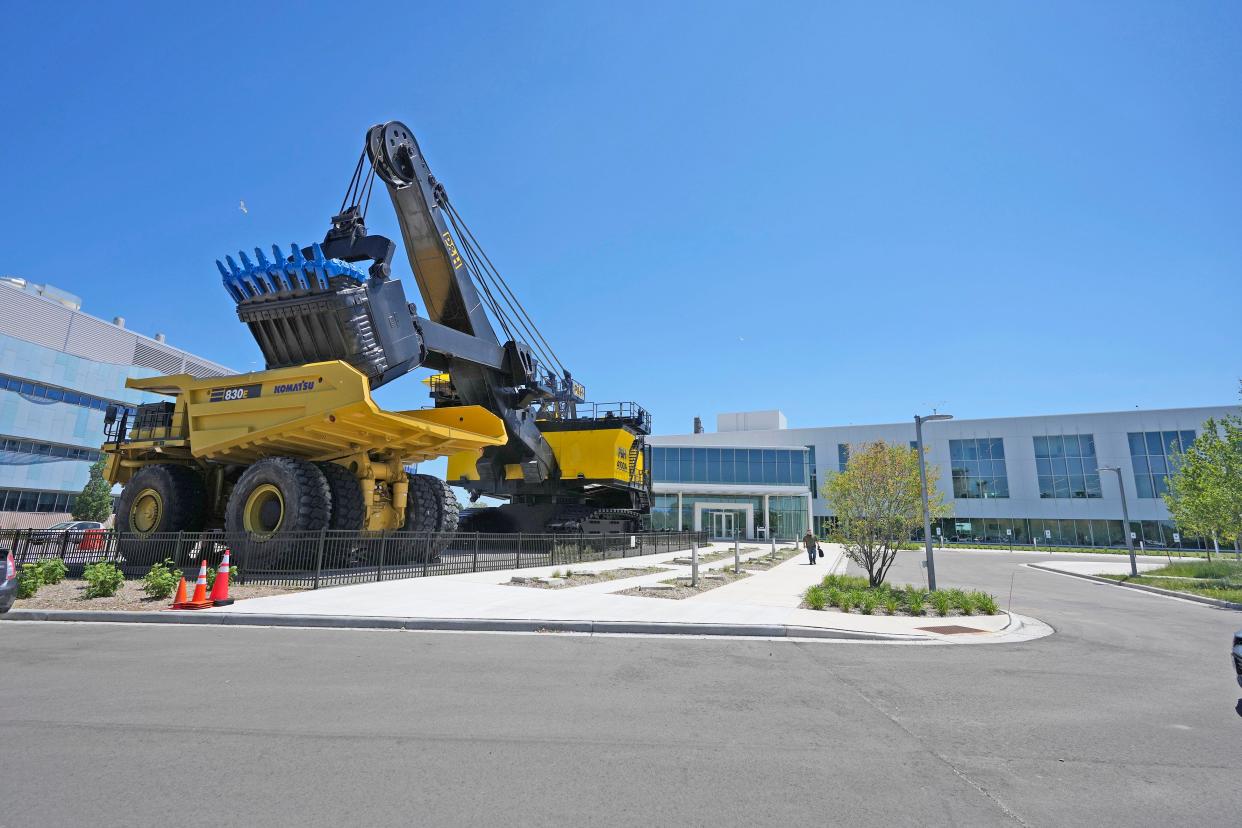 A large electric mining shovel highlights the entryway at Komatsu during the opening ceremony for its new $285 million-dollar campus in Milwaukee’s Harbor District on East Greenfield Avenue in Milwaukee on Monday. Komatsu’s new headquarters include a 180,000-square-foot office building and a 430,000-square-foot manufacturing facility.