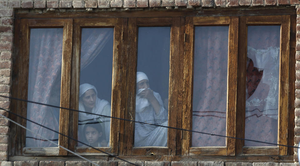 Kashmiri family watches protests