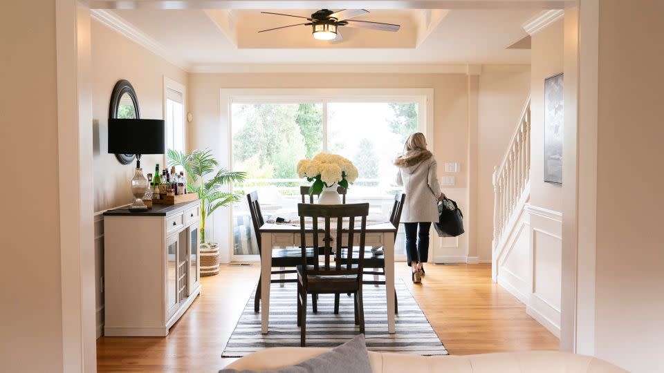 A realtor walks through the dining room during an open house at a home in Seattle, Washington, US, on Tuesday, March 26, 2024. The National Association of Realtors agreed to settle litigation over commission rules for US real estate agents, clearing the way for possible changes in how Americans buy and sell homes. - David Ryder/Bloomberg/Getty Images